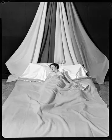 Image: Woman in bed asleep with book