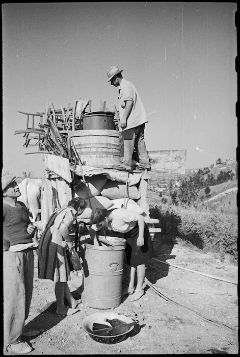 Italian civilians unloading their belongings in ruined town of Orsogna, World War II - Photograph taken by George Kaye