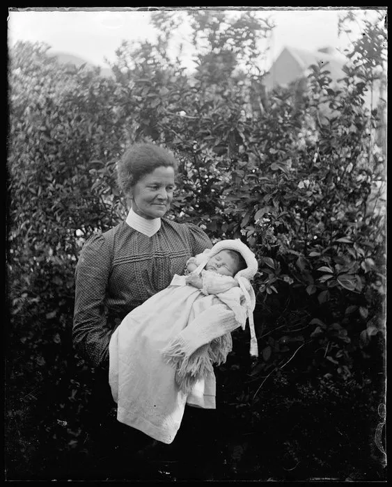Amy Kirk with a baby in nightgown