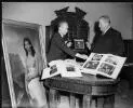 Portrait of  Rex Nan Kivell (left) handing over his collection of early Australian items to Senator the Hon. Sir Alistair [i.e. Alister] McMullin, President of the Senate, at a ceremony at Australia House, 16 January 1959 [picture] /