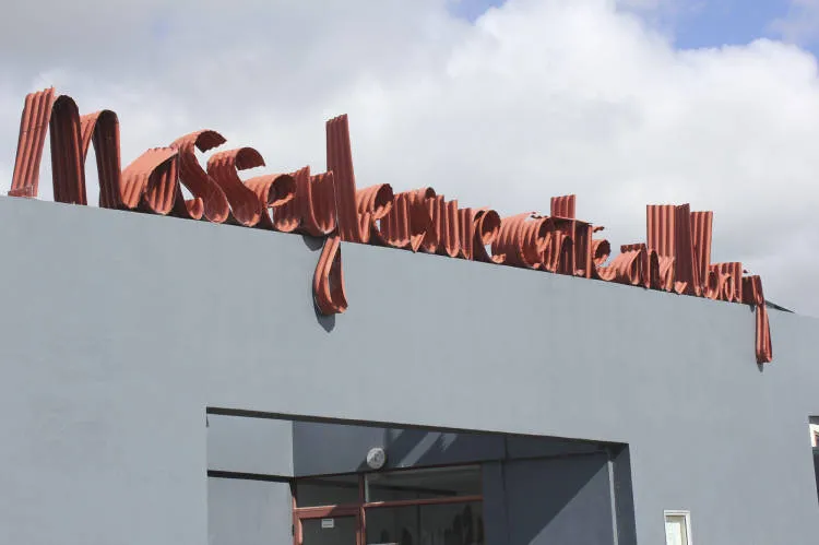 Jeff Thomson corrogated iron signage sculpture, Massey Leisure Centre and Library, Massey.
