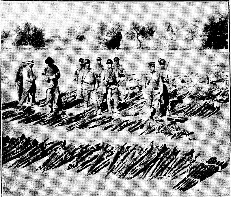 AFTER A SKIRMISH. Japanese troops taking tally of arms captured in one of the many recent skirmishes with the Chinese. (Ellesmere Guardian, 19 February 1932)