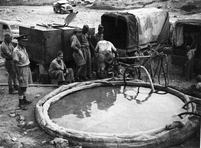 Gibson, R C, fl 1939 (Photographer) : Scene in Bardia, Libya, with World War 2 soldiers alongside a water supply