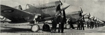 Image: Mechanics attached to the squadron stand by the Kittyhawks after checking the machines' engines