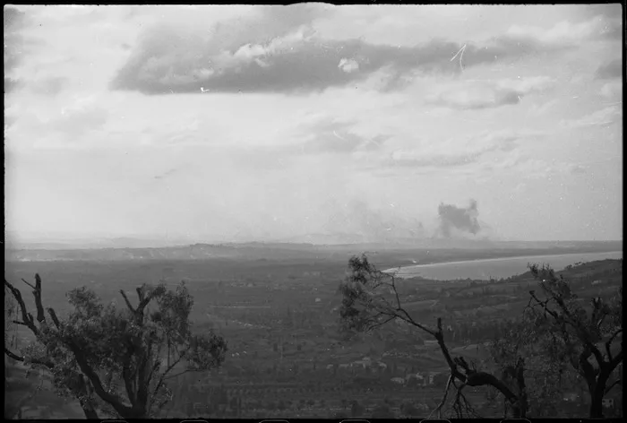 Smoke rising from Rimini, Italy, as it is being heavily bombarded in World War II - Photograph taken by George Kaye
