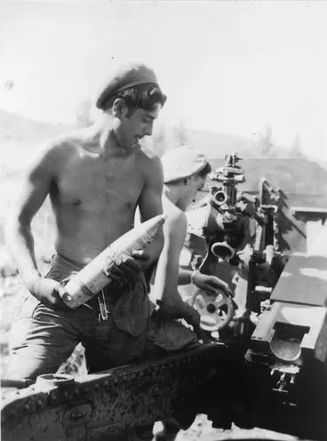 Image: [Gunner G Horsefall standing by to reload a 25 pounder, Korea]