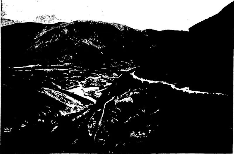 VIEW OF ARTHUR'S POINT FROM MOKE CREEK TRACK.  The Shotover River is seen on th« left, and on the old Sew Hoy Beach claim lies the unfortunate Arthur's Point Dredge, since bought by the Rise and Shine Company, and erected on their second claim on the Clutha. (Otago Witness, 30 September 1903)