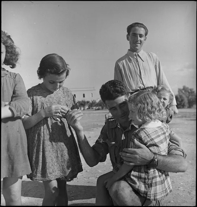 Fred Campbell makes friends with Italian children near Taranto during World War II