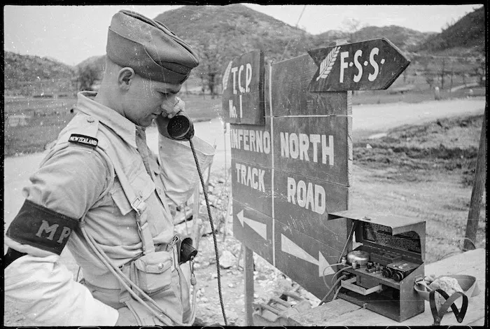 A NZ Division Provost (J J Morgan) on the phone, at the start of the Inferno track in the Cassino area - Photograph taken by George Frederick Kaye
