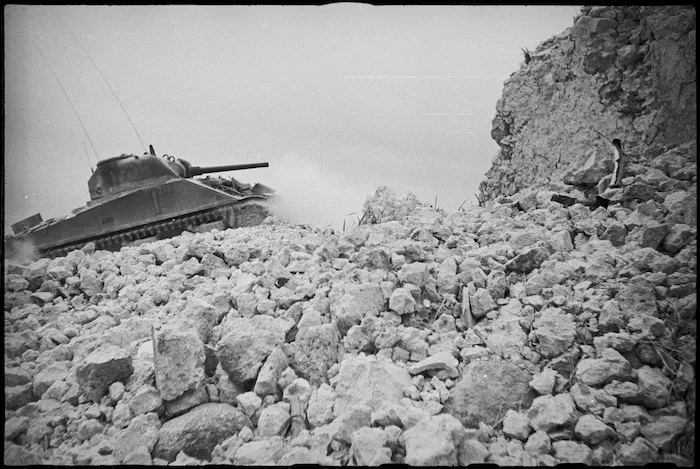 NZ Sherman tank among ruins of village on the Cassino Front, Italy, World War II - Photograph taken by George Kaye