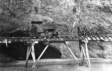 Image: Steam locomotive on tramway by cliffs, north of Whatipu.