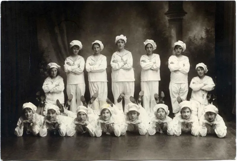 Fifteen young women in sailor costume.