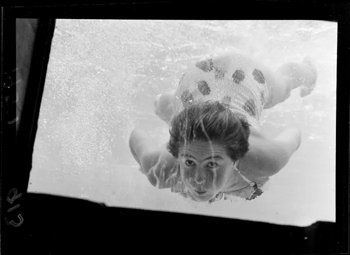 An unidentified girl swimming to the underwater window at the Naenae Olympic Pool, Lower Hutt