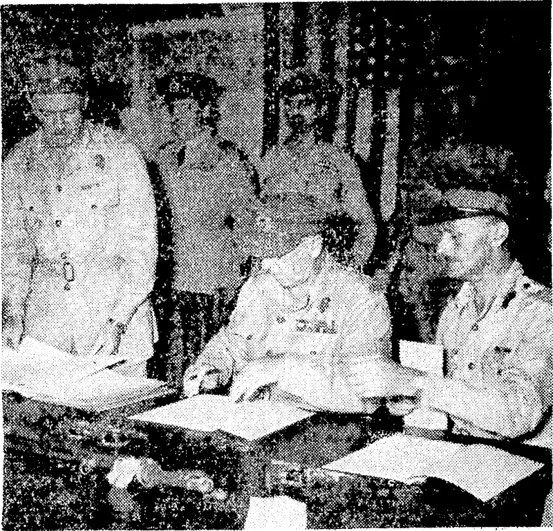 11..VZ.A.F. Official Photograph. The Australian G.0.C., LieuL-General S. G. Savige, signing the .surrender documents ivkich the Japanese commanders, General. Kanda and Vice-Admiral Baron Samejlma, were taken to Torokina to sign. At the left of the back row is the New Zealand representative, Air Commodore G. JV. Roberts. (Evening Post, 17 September 1945)