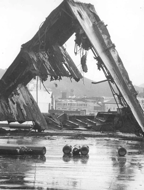 C & A Odlin Timber & Hardware Co Ltd: 1969 Looking through part of the wreck of the vessel "Wahine" lifted from the Wellington Harbour seabed (sank 10Apr1968), Odlins Pinex Centre in background