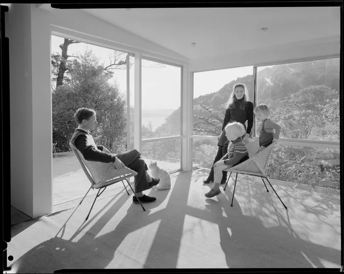 Family group in living room of unidentified house