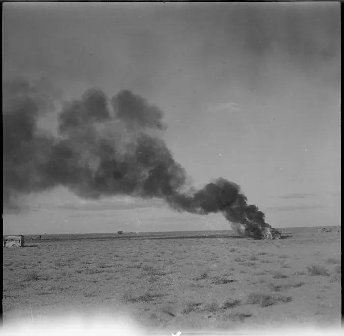 Trucks burning following air attack during the advance into Libya, World War II