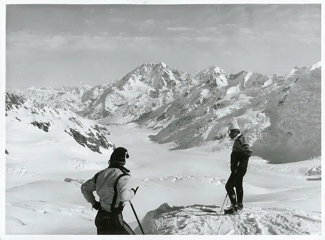Two Japanese skiers (Yuichiro Miura on right) survey the ski-run down the Tasman Glacier from the glacier's head. Mt. Cook.