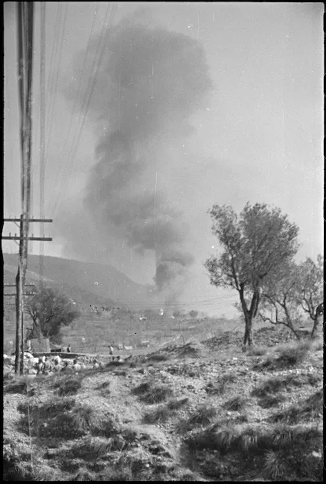 Smoke from large ammunition dump burning behind the lines in NZ Sector of 5th Army Front in Italy, World War II - Photograph taken by George Kaye