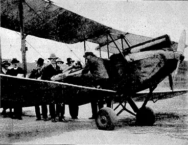 Image: Evening Post" Photo. TO AID IN ORGANISING A CHARITY • FLIGHT.-TAc Mayor's Relief of > Distress -Fwid^tlie Smith Family, the Cdy .Mission, and the PlunketSociety are all'interested in the special charity flight to* be given by. Sir Charles Kings ford Smith. Yesterday Mr. A. W. Nisbet, secretary., of the Wellington Aero Club;JejssZmeroplane:tocarry\qut_ somepj'-the' advance work.of the.scheme. .' (Evening Post, 05 January 1933)