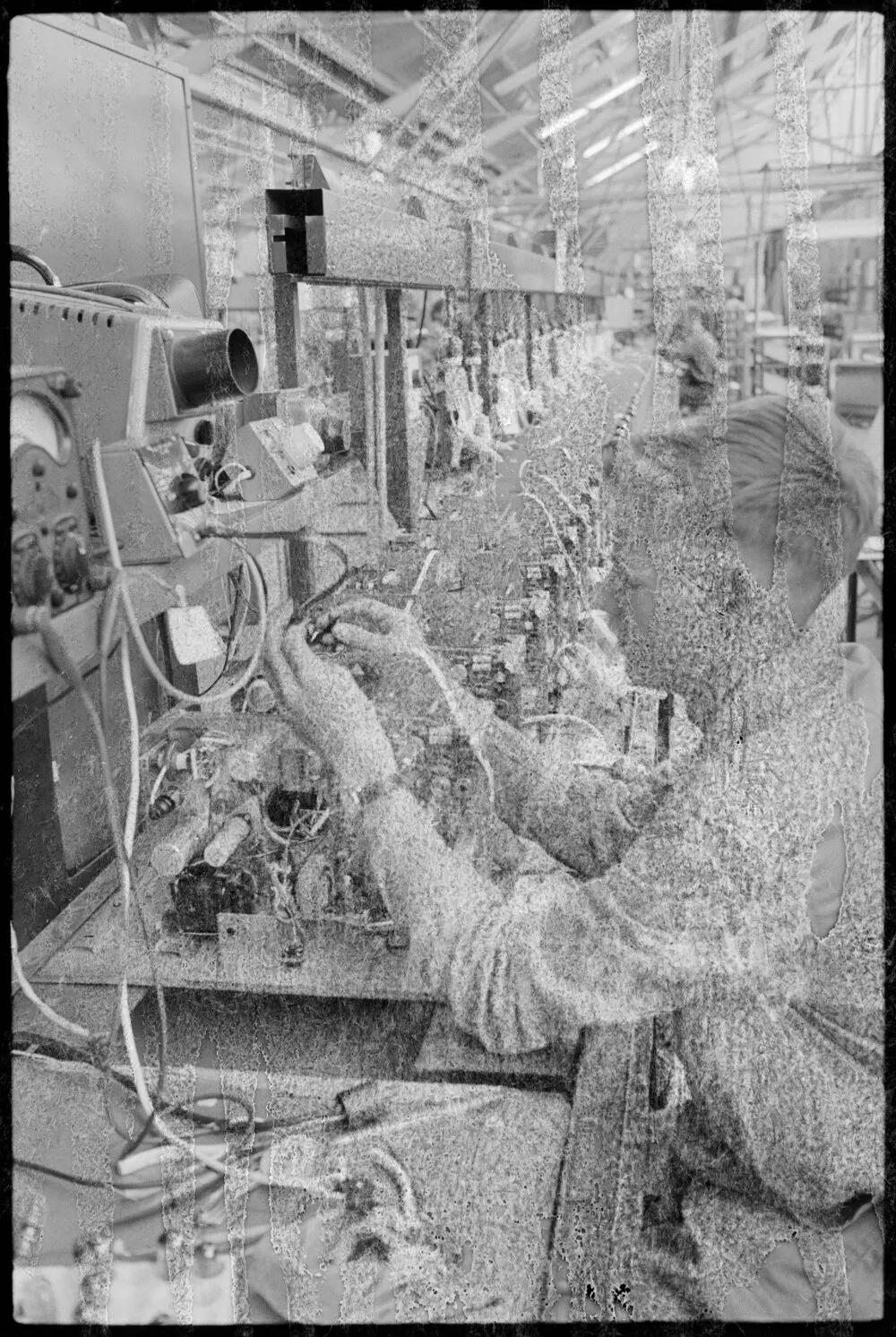TISCO. A technician watching a dial while he winds on the coil for T.V. receiver