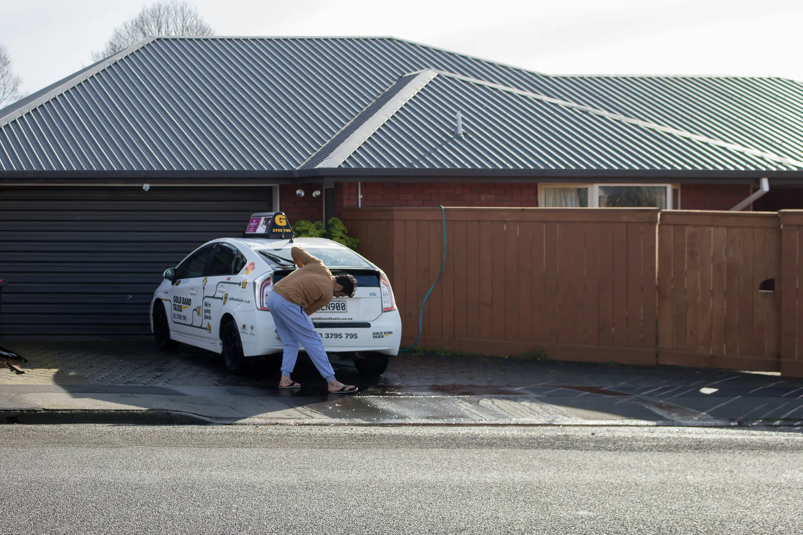 Taxi driver washing his car