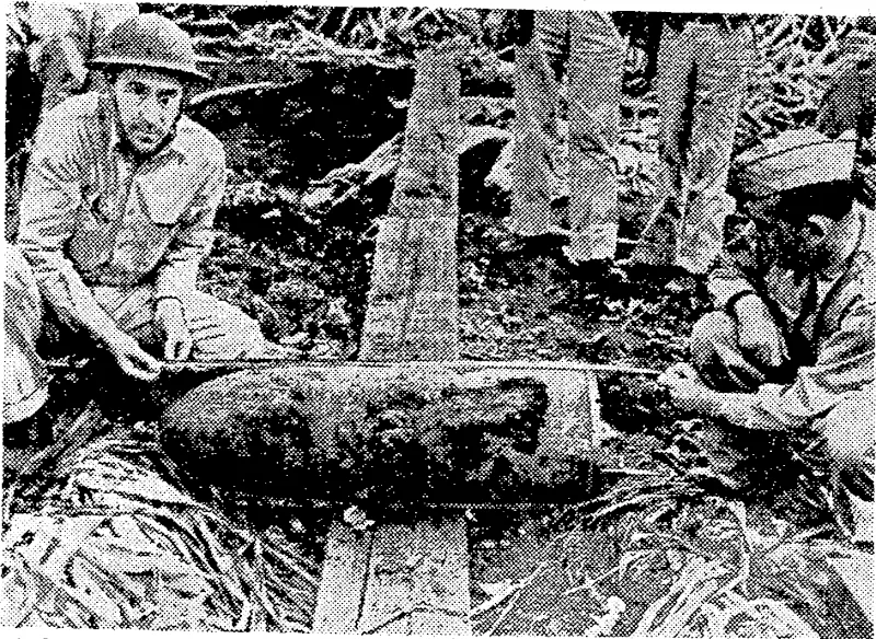 Soldiers in Hawaii measuring a Japanese bomb which failed to explode when dropped during the raid on Pearl Harbour. (Evening Post, 05 March 1942)
