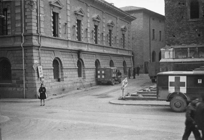 James G Brown, fl 1945 (Photographer) : 4th main dressing station at Faenza, Italy, occupying two bank buildings in the centre of town, with ambulances alongside