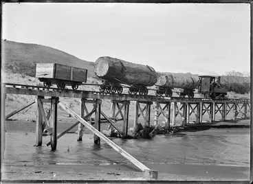Image: "A" 196 steam locomotive hauling kauri logs across Maori Creek, near Piha