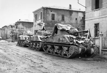 Image: Wilson, Stuart, fl 1944 :Tanks of 2nd NZEF, 19th Armoured Regiment, under falling snow on Christmas Eve, at Faenza, Italy