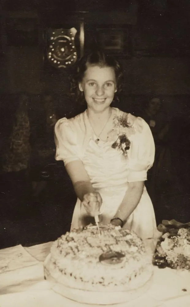 Joan Larsen cuts the cake at her 21st birthday party