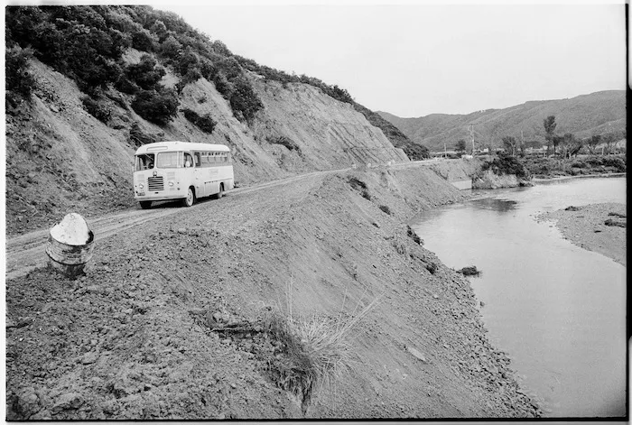 School bus on a road beside the Wainui Stream