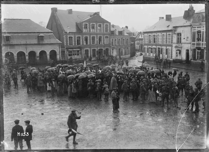Crowd around a New Zealand regimental band playing in Le Quesnoy, the day after its capture