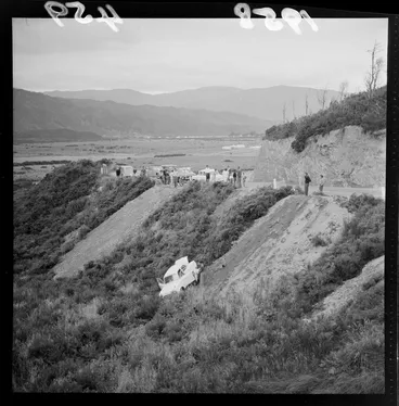 Image: A car over a bank at Wainuiomata