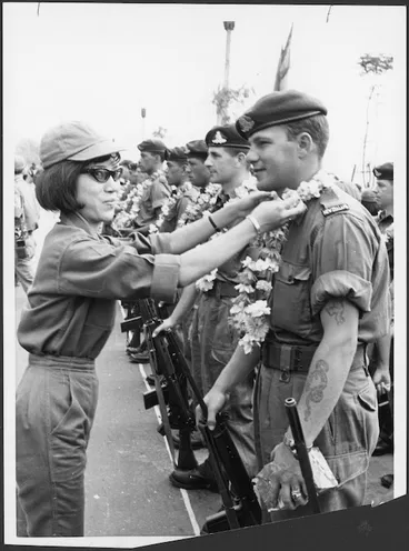 Image: New Zealand soldier presented with a garland of flowers by a woman from the Vietnamese Army, Saigon, Vietnam - Photograph taken by Associated Press