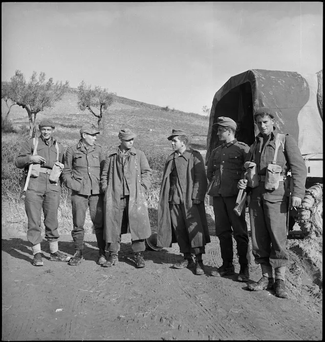 New Zealanders guarding first prisoners taken by the NZ Division on the Sangro River front, Italy, World War II - Photograph taken by George Kaye