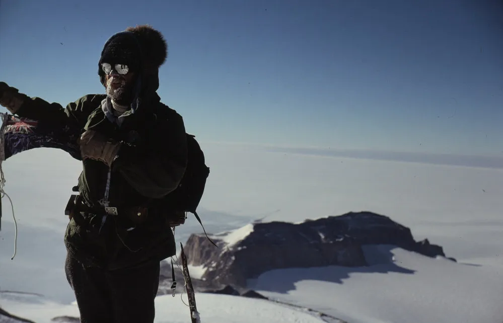 Karl Kellogg Holding NZ Flag on Summit of Mount Glossopteris