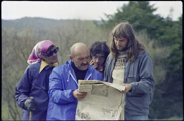 Image: Vivian Hutchinson, Turi Blake, and others reading a newspaper