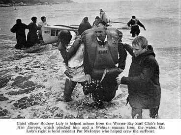 Image: Chief officer Rodney Luly is helped ashore from the Worser Bay Surf Club's boat Miss Europa, which plucked him and a Wahine seaman from the water. On Luly's right is local resident Pat Mclntyre who helped crew the surtboat