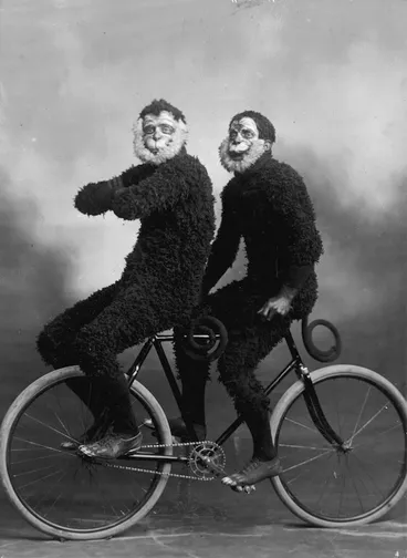 Image: Members of the Invercargill Cycling Club riding a bicycle in monkey costume