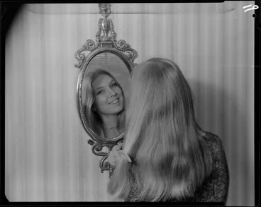 Image: Woman looking in mirror