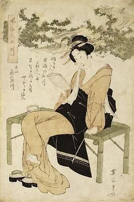 A lady seated on a bamboo bench reading