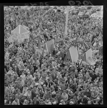 Image: James Smith's Christmas Parade with Father Christmas sleigh float surrounded by a crowd, Wellington Region