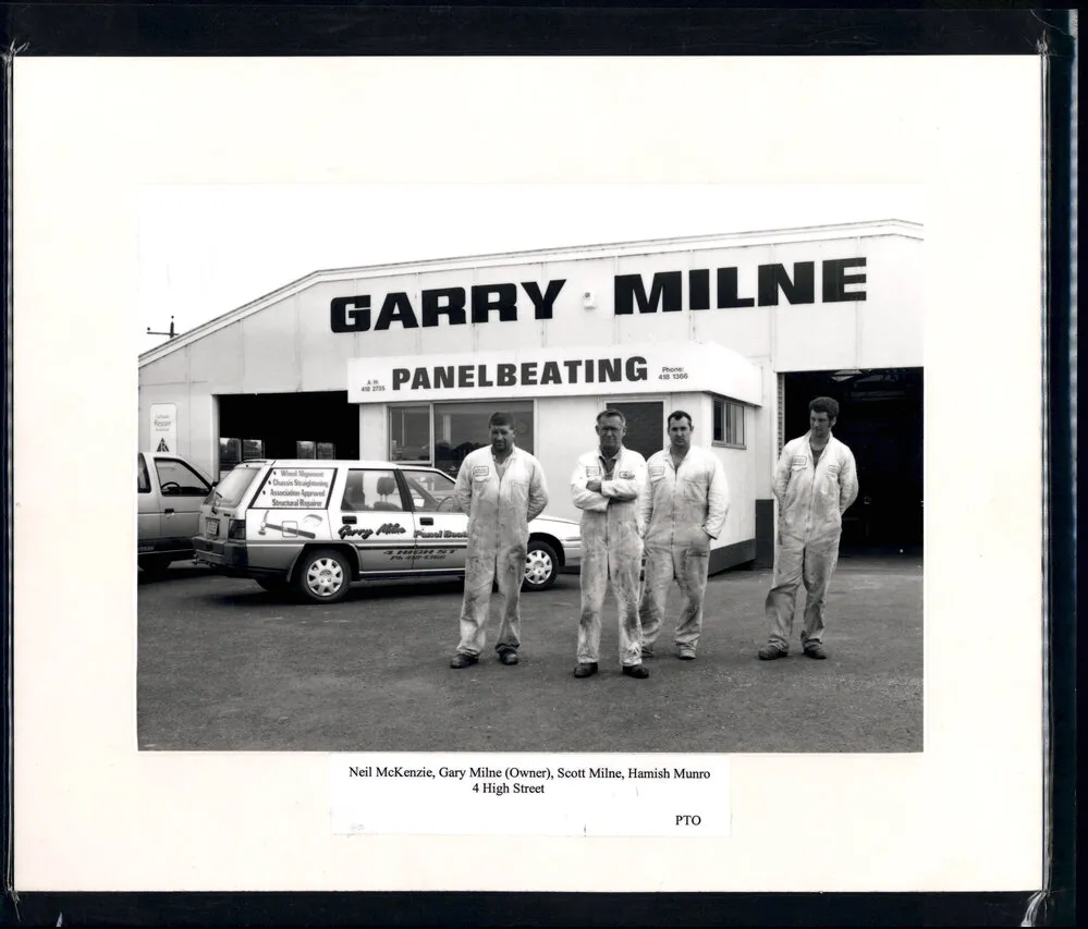Gary Milne outside of business with staff