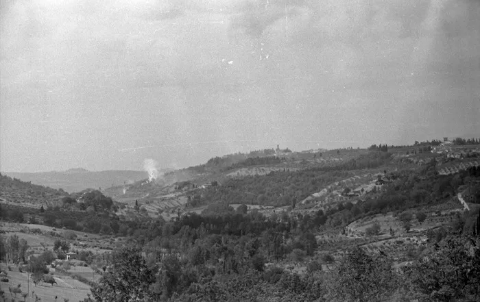 Shows smoke from enemy shell fire drifting over a ridge in the forward areas as the New Zealand Division draws close to Florence