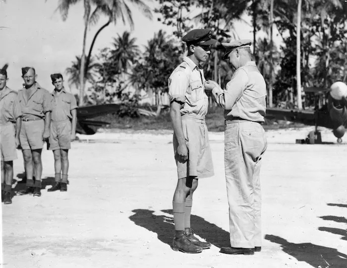 Brigadier-General R L Owens, presenting the American Distinguished Flying Cross to Flying Officer M T Vanderpump