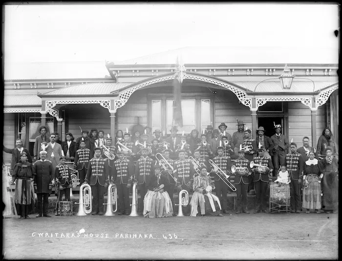 Members of a brass band, and others, outside the house of Charles Waitara, at Parihaka