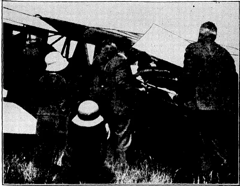 C. B. Fitzgerald Photo. AEROPLANE AMBULANCE IN USE.—The Wellington Aero Club's new Waco ambulance was put into commission; yesterday for the first time, when it was used to transfer an invalid from Dunlop Field Aerodrome, Hawera, to Alma Aerodrome, Oamaru. The invalid, who was accompanied by a nurse, is seen being placed on the machine in a stretcher at Hawera. (Evening Post, 14 December 1933)
