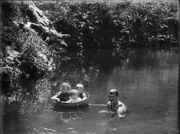 Image: Man and children swimming in a river, Northland