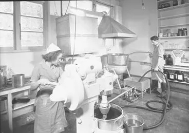 Image: [Woman operating machine]